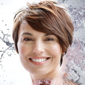 Closeup of a Woman Smiling With Water Splashing